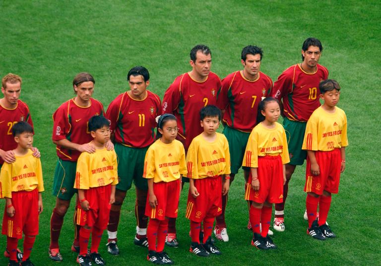 Football - 2002 FIFA World Cup Korea/Japan(tm) , Group D , Poland v USA , Daejeon World Cup Stadium , Daejeon , Korea , 14/6/02.Portugal players line up with McDonald's Players Escorts , Youth Programmes.Mandatory Credit:Action Images / Richard Heathcote.Digital...
