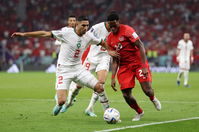DOHA, QATAR - DECEMBER 01: Jonathan David of Canada controls the ball against Achraf Hakimi of Morocco during the FIFA World Cup Qatar 2022 Group F match between Canada and Morocco at Al Thumama Stadium on December 01, 2022 in Doha, Qatar. (Photo by Richard Heathcote/Getty Images)
